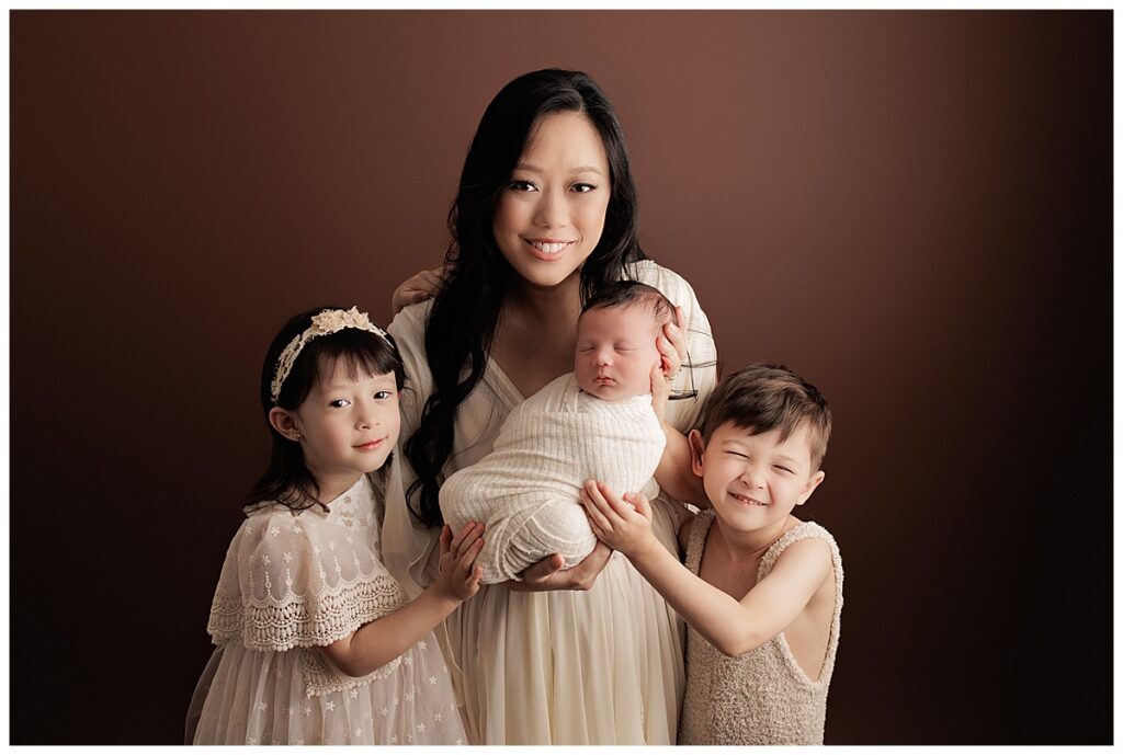 Mom holds kids close for Silver Spring Newborn Photographer