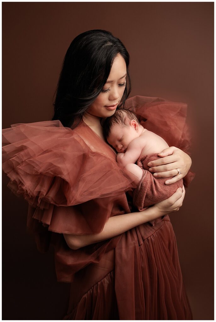 Sleepy newborn lays on mother's chest for Silver Spring Newborn Photographer