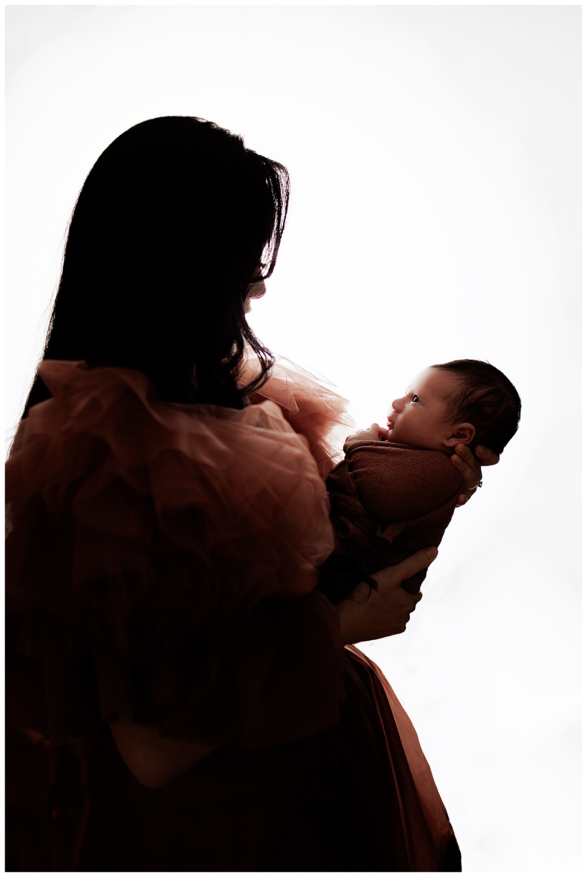 Mom and smiles at newborn showing the Best Time For Your Newborn Session