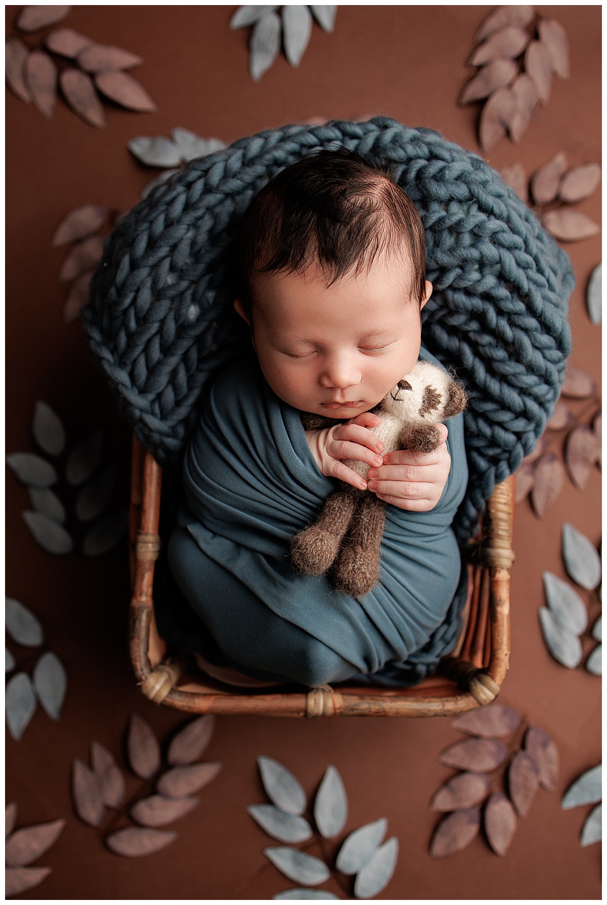 Baby lays wrapped in blanket and in a basket for Silver Spring Newborn Photographer