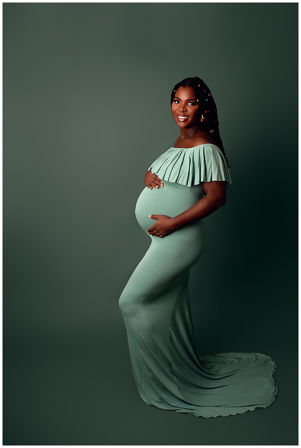 Female holds her pregnant belly for Yaffa Koff Photography