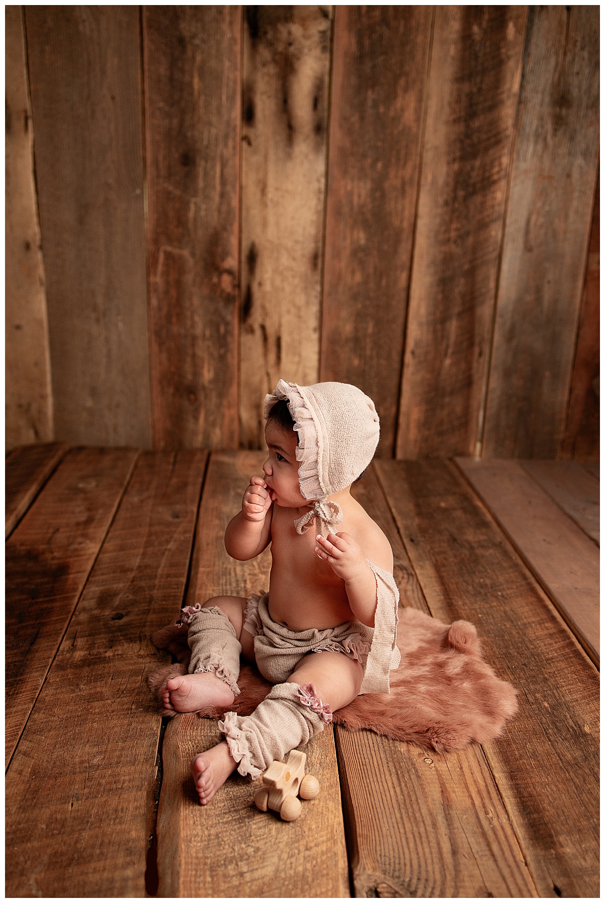 Young baby sits on the floor during a set of Milestone Sessions