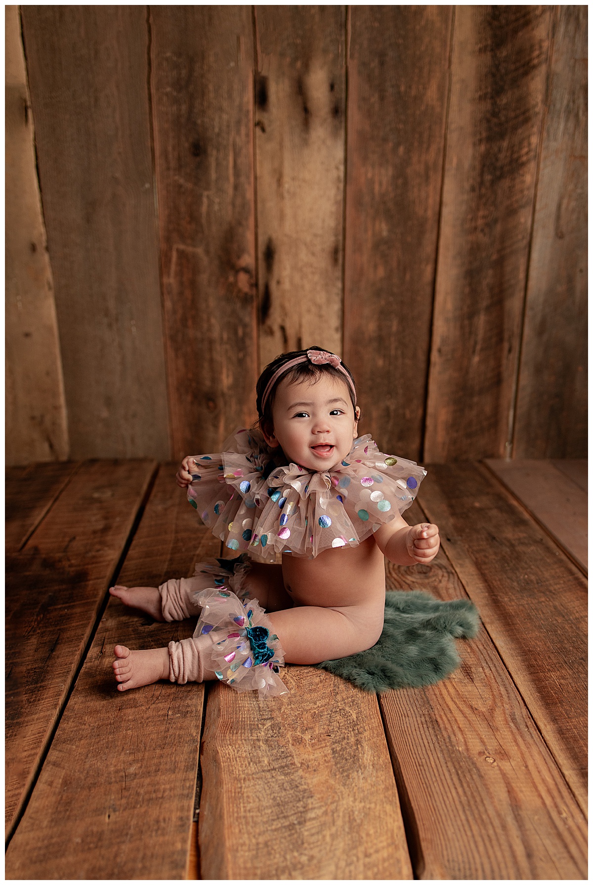 Young child sits on the floor for Yaffa Koff Photography