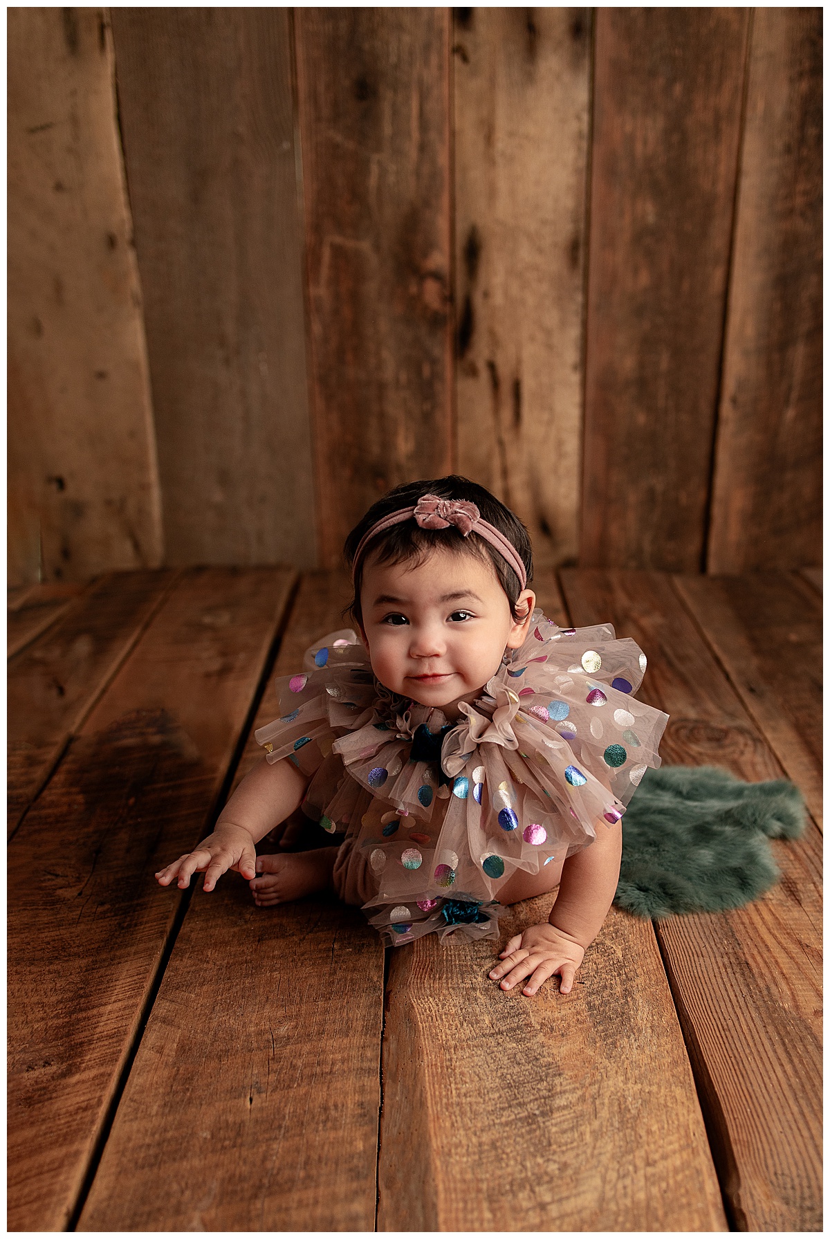 Baby crawls on the floor during a set of Milestone Sessions