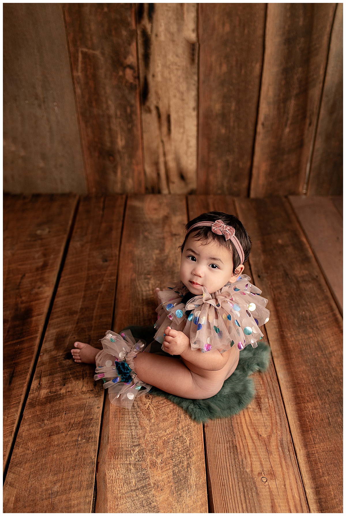 Young child sits on the floor for Silver Spring Newborn Photographer