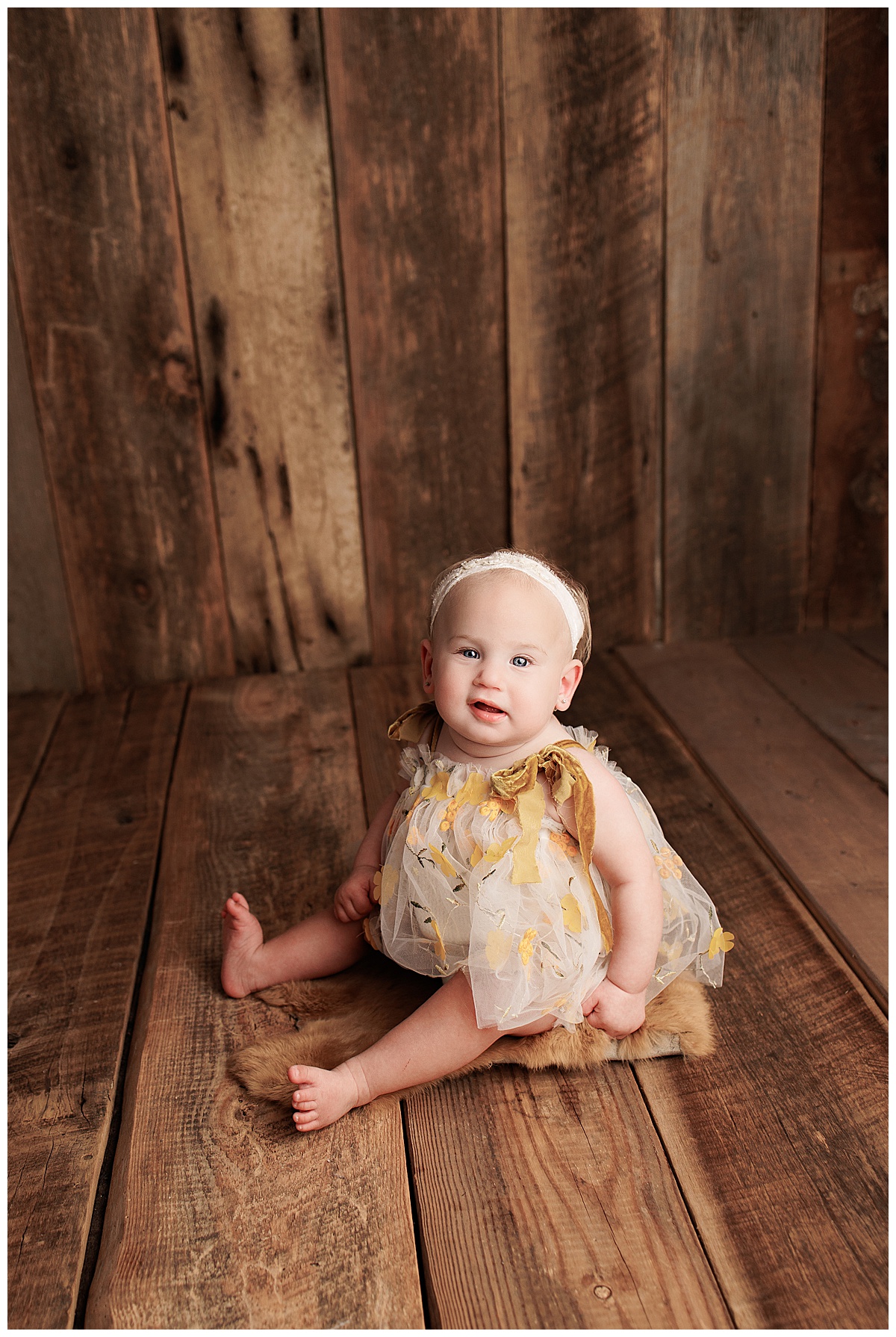 Young baby sits on the floor for Silver Spring Newborn Photographer