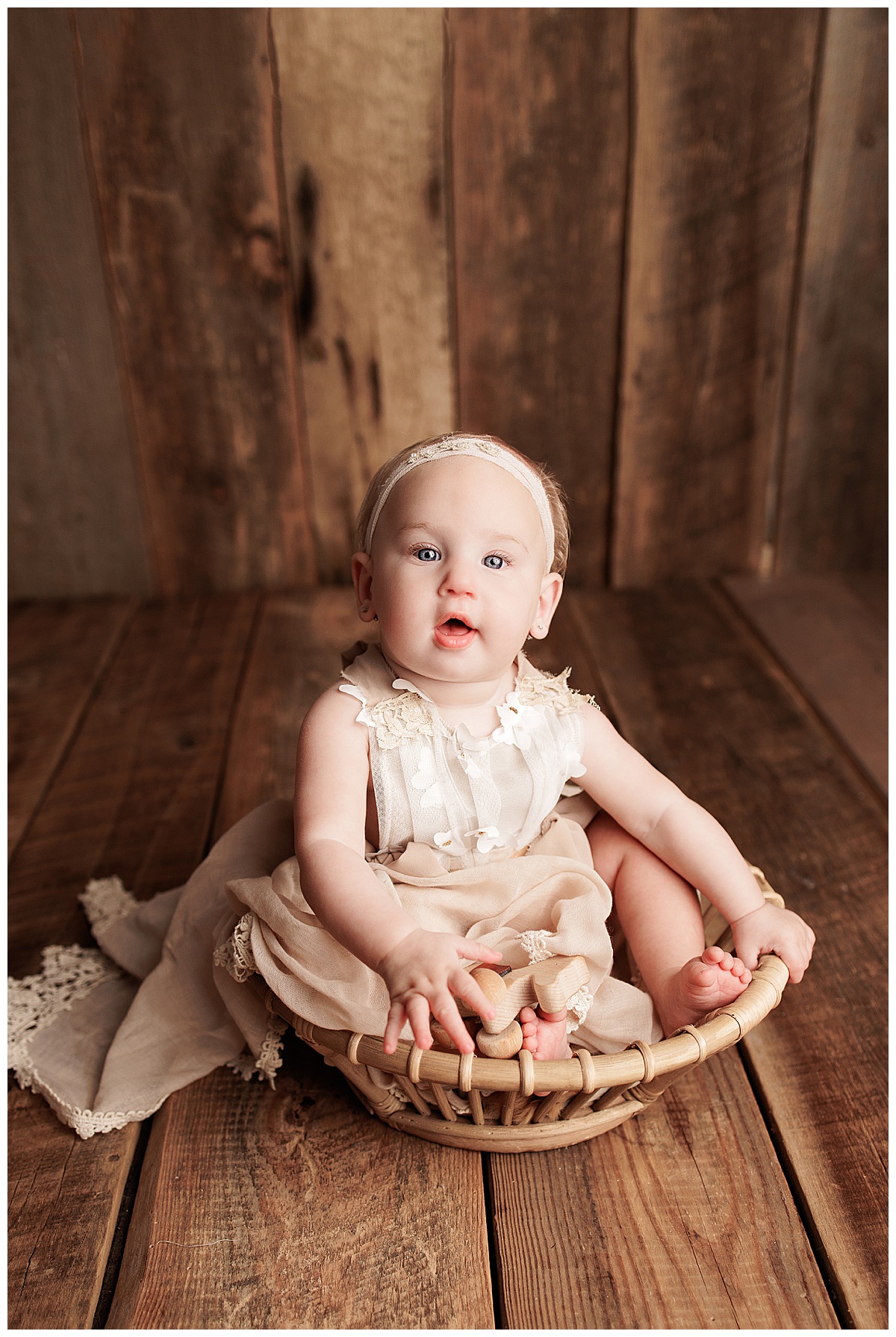 Young baby girl sits on the floor for Silver Spring Newborn Photographer