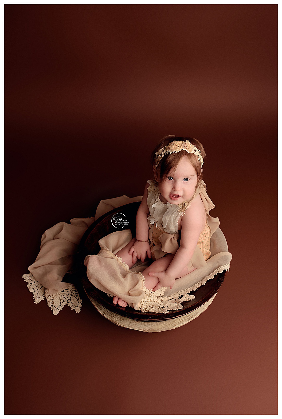 Baby sits in a basket for Silver Spring Newborn Photographer