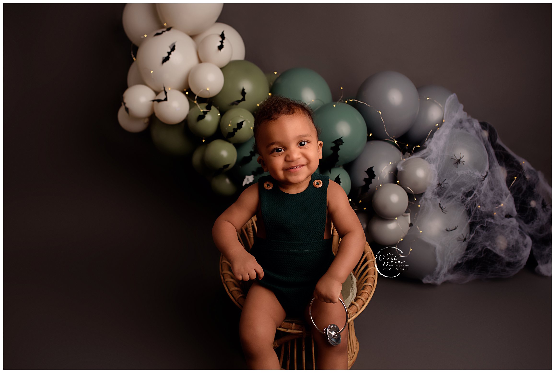 Young baby sits down and smiles big for Silver Spring Newborn Photographer