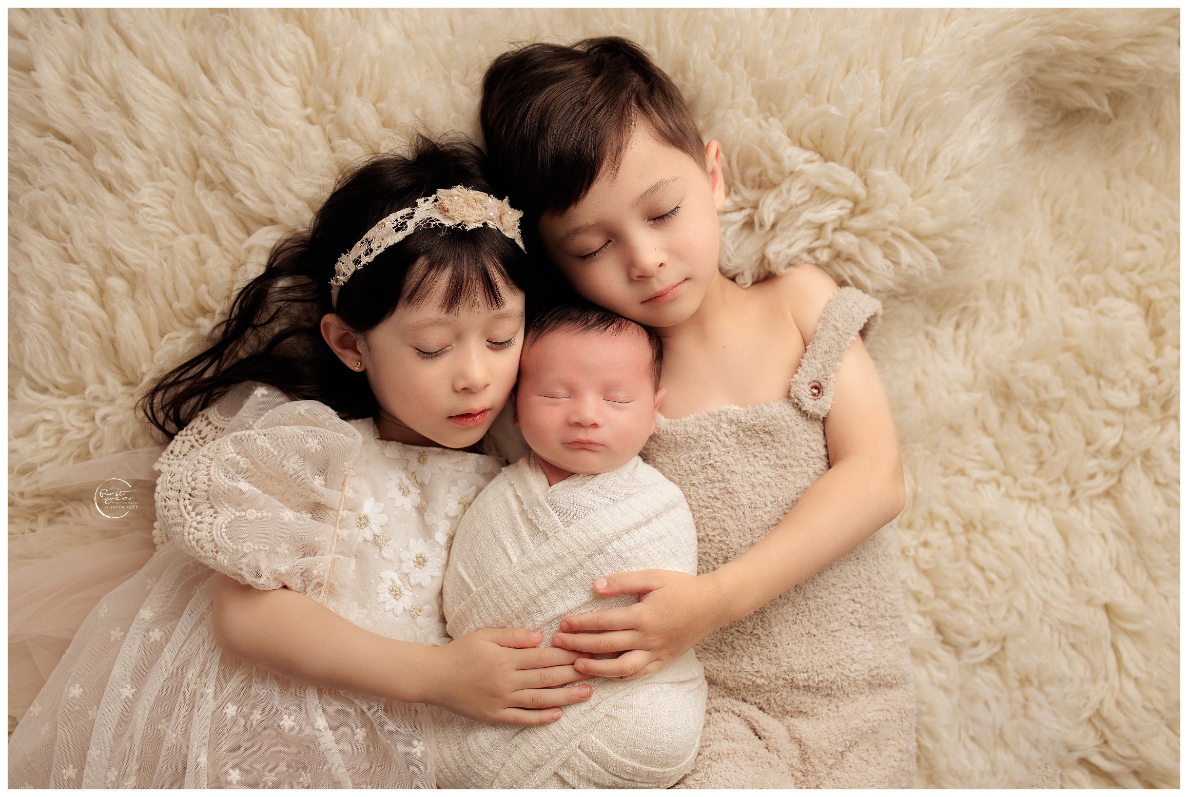 Siblings cuddle young baby for Silver Spring Newborn Photographer