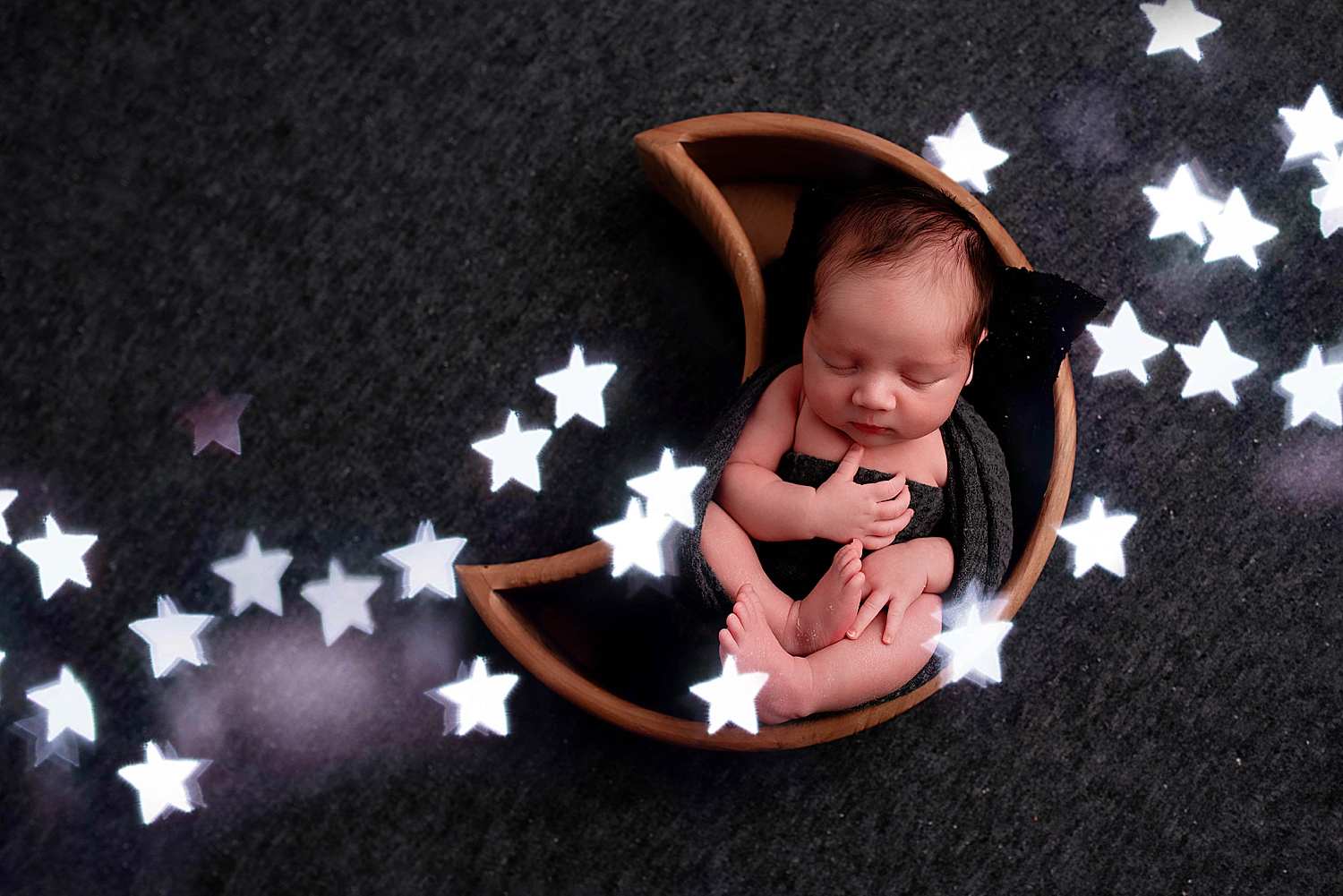 infant sleeps in moon box surrounded by stars to show how to personalize your session