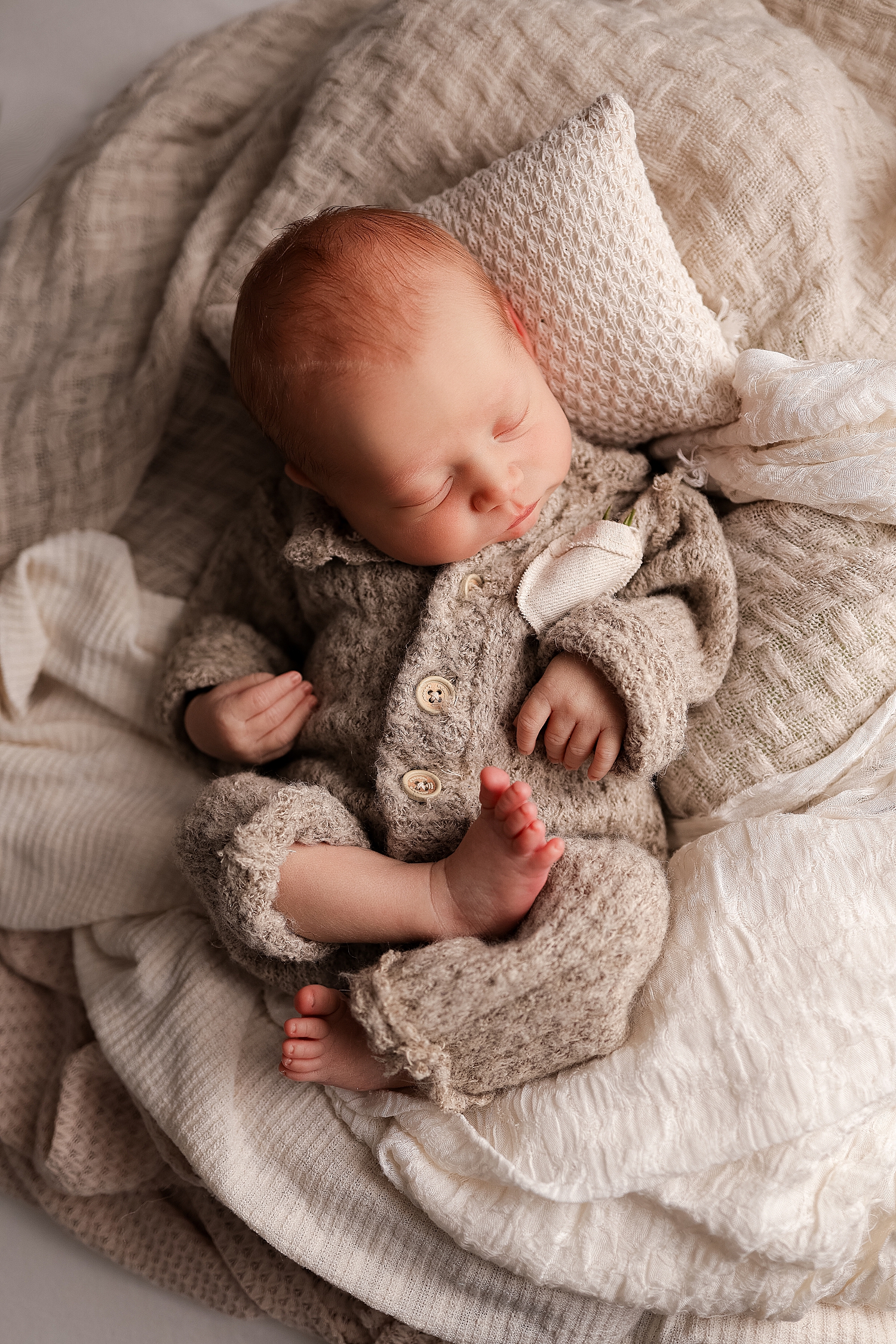 baby boy lying on waffle knit blanket by Yaffa Koff Photography