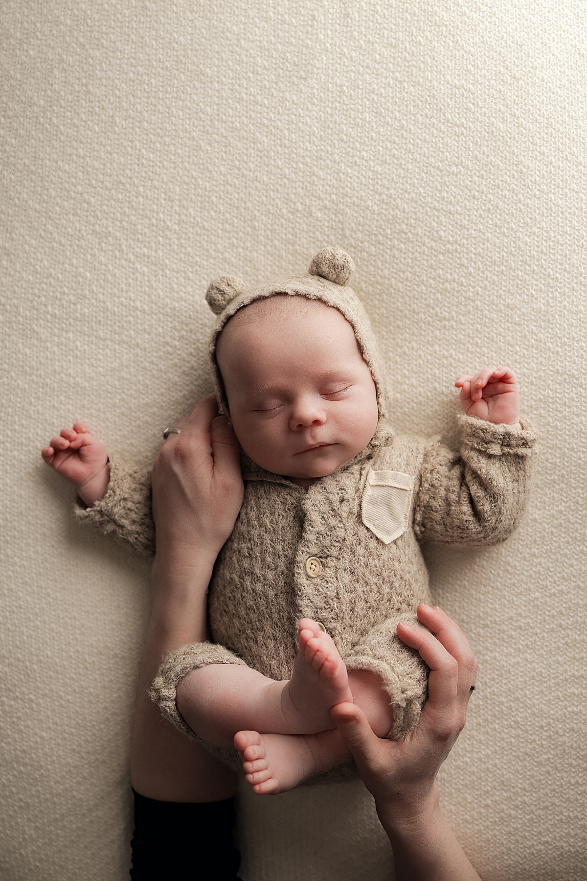 mother holds arms around baby for One Month Shoot